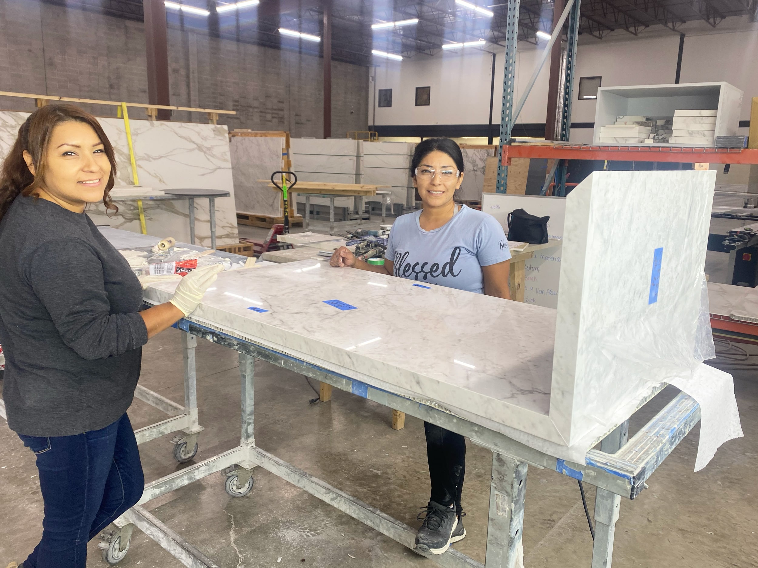 Employee Spotlight: Lupe Aguliar | Lupe Aguliar works with coworker to complete porcelain table.